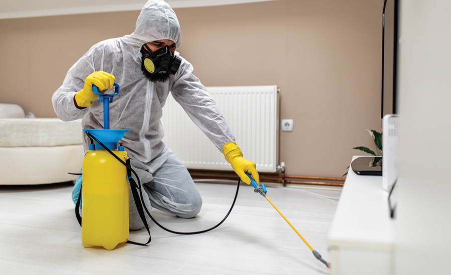 person wearing PPE cleaning